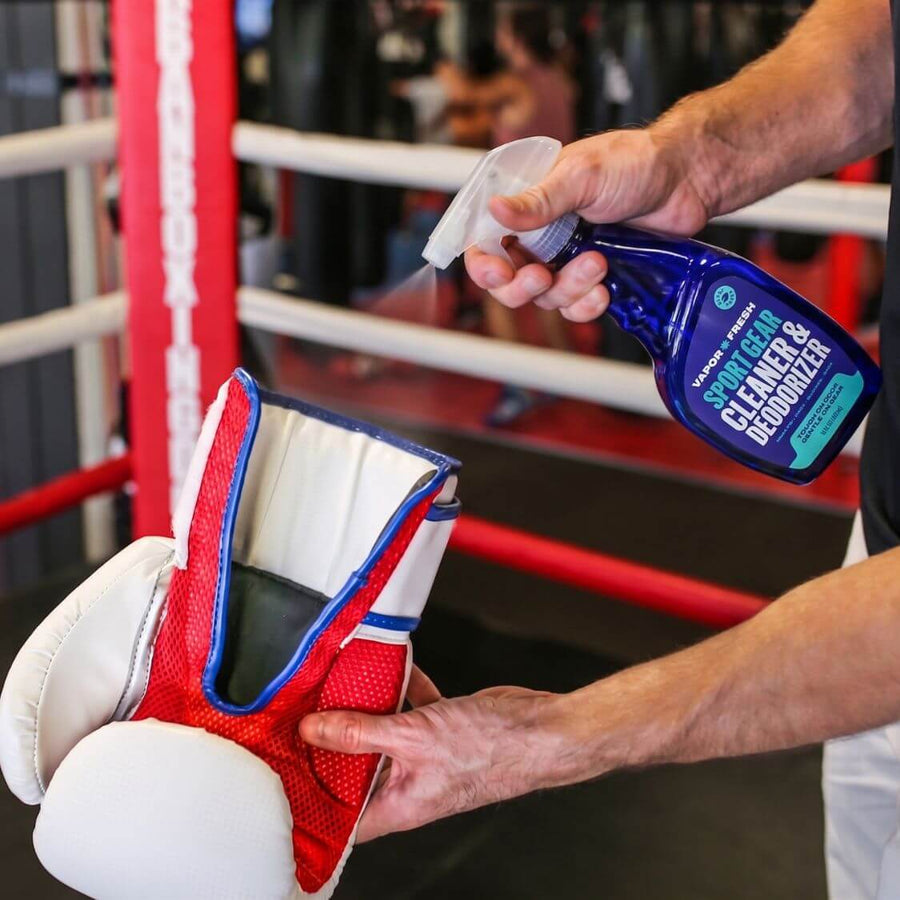 Spraying Vapor Fresh on boxing gloves